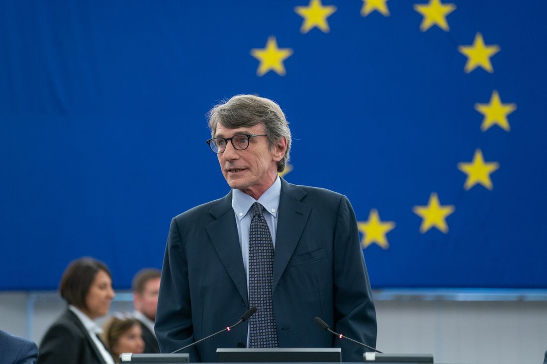 David Maria Sassoli speaks in the European Parliament chamber, in front of the blue flag with the stars of the Union